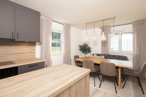 a kitchen and dining room with a table and chairs at Familienparadies - Chalet Hoamatl in Achenkirch