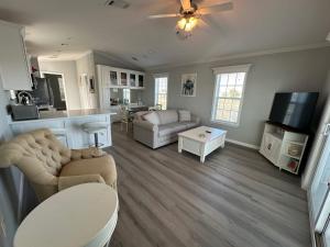 a living room with a couch and a table at Lake Front, Beach Retreat in Fort Myers Beach