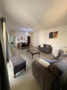 a living room with a couch and a table at Haidar house in Baabda