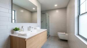 a bathroom with a sink and a toilet and a mirror at Bertinas stay in Diepholz