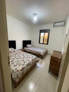 a room with two beds and a window at Haidar house in Baabda
