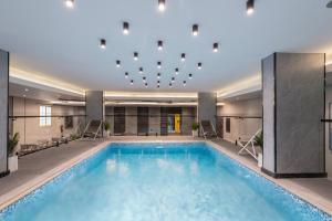 a swimming pool in a hotel with a ceiling at Warwick Al Baha Hotel in Baljurashi