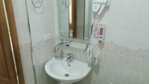 a bathroom with a sink and a mirror at SILVER Inn in Bukhara +62 photos