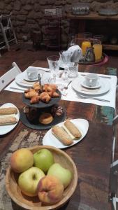 a wooden table with plates of food on it at La Casa del Miracle, hostal in Balaguer