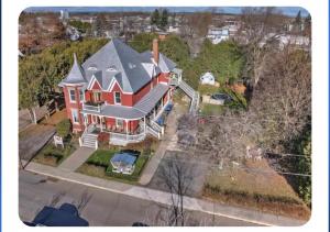 an aerial view of a large red house at La Victorienne in Louiseville