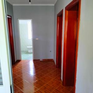 an empty room with a hallway with a tile floor at Beach Guest House in Durrës +9 photos