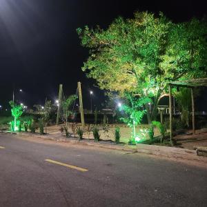 a park at night with a playground with green lights at Noite hotel sul aeroporto in Palmas