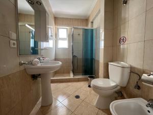 a bathroom with a toilet and a sink and a shower at Apartment Katherina Sarande in Sarandë +51 photos