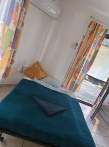 a bed in a room with a window at Elo Apartman in Csokonyavisonta