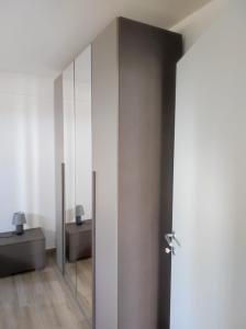 a bathroom with a sliding door with a mirror at Residence Mancini - Cilento Home & Sunset in Rocca Cilento