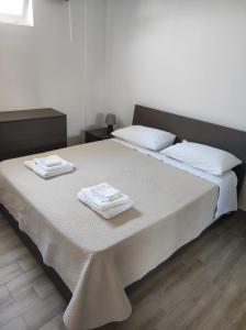 a bedroom with a bed with two towels on it at Residence Mancini - Cilento Home & Sunset in Rocca Cilento