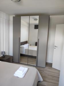 a bedroom with a mirror and a bed in it at Residence Mancini - Cilento Home & Sunset in Rocca Cilento