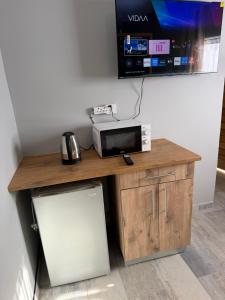 a microwave sitting on a table with a refrigerator at Highveld Nook in Sasolburg