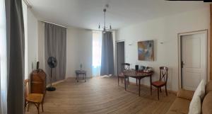 a living room with a table and chairs at Le Dorat Bright & Quiet in Le Dorat