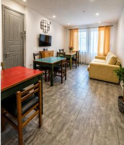 a living room with a couch and a table at Hostel-Élisée-Perpignan in Perpignan