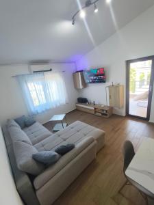 a living room with a couch and a tv at Apartments Nagj in Sveti Juraj