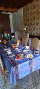 a blue table with plates of food on it at Domaine de Béchegut in Marval +1 photo