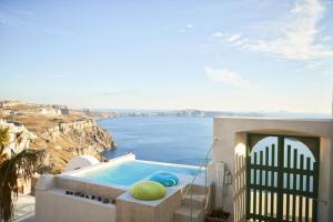 a house with a swimming pool with a view of the ocean at Villa Murat in Fira