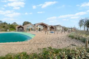 an image of a playground at a resort at Chalet Huffels P12 - Camping De Nollen Callantsoog in Callantsoog