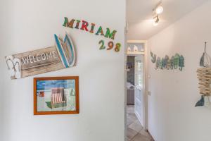 a hallway of a home with a sign on the wall at Vakantiehuis Miriam op park Strandslag Julianadorp aan Zee in Julianadorp