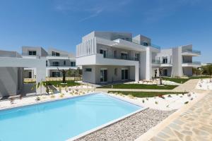 an external view of a villa with a swimming pool at Viasol Suites Thassos in Skala Rachoniou