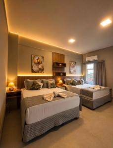 a hotel room with two beds in a room at Hotel Dal Flora in Sorriso