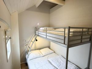 a bunk bed room with two bunk beds in it at Texelheerlijk 1 in De Koog
