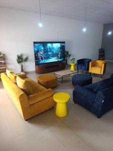 a living room with couches and a flat screen tv at Casa Erica in Soyo