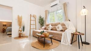 a living room with a couch and a table at Lavoe Villas Samui in Nathon Bay