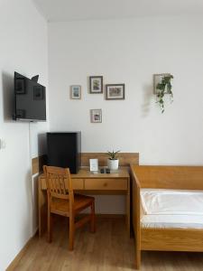 a bedroom with a desk with a bed and a computer at Vinarija Andjusic in Dračevo