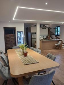 a dining room table with chairs and a kitchen at Villa Clair de Lagon in Blue Bay