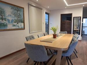 a dining room with a wooden table and chairs at Villa Clair de Lagon in Blue Bay