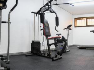 a gym with several tread machines in a room at Next To Apartment Hotel in Pretoria