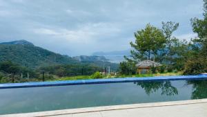 a swimming pool with a view of the mountains at Iztuzu Sunset Villa in Gökbel