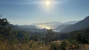 a view of a valley with a lake in the distance at Iztuzu Sunset Villa in Gökbel