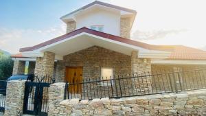 a house with a fence in front of it at Iztuzu Sunset Villa in Gökbel +1 photo