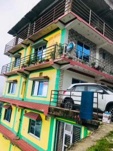 a car parked in front of a colorful building at Gauri Shanker Hotel and Lodge in Dharān Bāzār