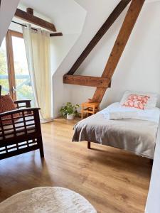a bedroom with a bed and a large window at Normandy Inn in Montbray