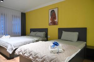 a bedroom with two beds with towels on them at Juna's Hotel in Prizren