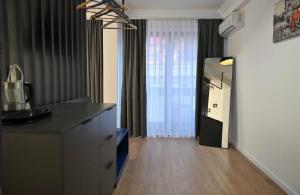 a living room with a counter and a large window at Juna's Hotel in Prizren