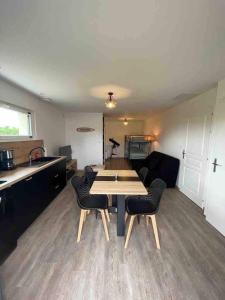 a living room with a table and some chairs at Studio paisible, 30m2 in La Souterraine