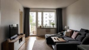a living room with a couch and a tv at Boehring Apartments in Dötlingen