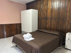 a bedroom with a bed and a white cabinet at Residenza delle Rose in Viggianello