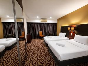 a hotel room with two beds and chairs at Cozy Studio at SCSP Suites in Kota Kinabalu +143 photos