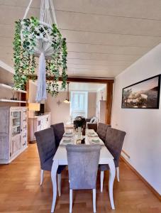 a dining room with a white table and chairs at Ferienwohnung Haus Kreutz in Bruttig-Fankel