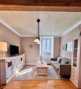 a living room with a couch and a tv at Ferienwohnung Haus Kreutz in Bruttig-Fankel