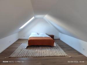 a bedroom with a bed in a attic at Ty eno in Plourin