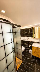 a bathroom with a toilet and a sink at Raha Villa Bungalow in Uzungöl +43 photos