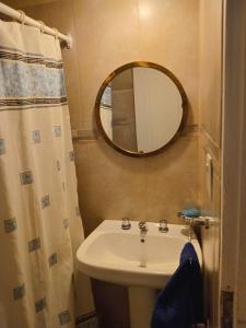 a bathroom with a sink and a mirror at Casiopea bungalo in San Carlos de Bariloche
