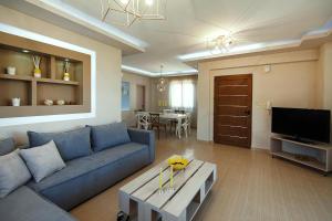 a living room with a blue couch and a table at Cottage in Adele in Ádhele +28 photos
